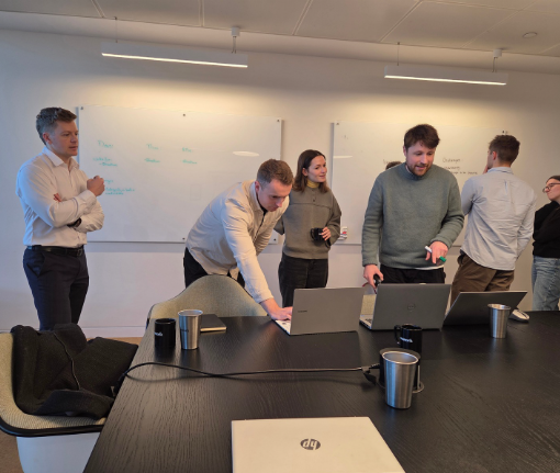 People Champions coaches working with a leadership team around a table